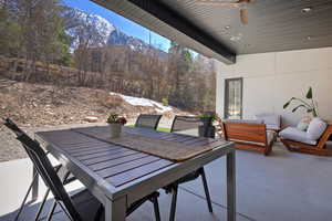 View of patio with an outdoor hangout area, outdoor dining area, and ceiling fan