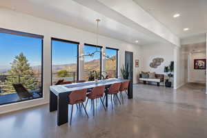Dining space with baseboards, recessed lighting, concrete floors, and a mountain view