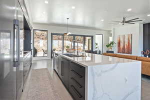Kitchen featuring modern cabinets, recessed lighting, appliances with stainless steel finishes, a sink, and a spacious island