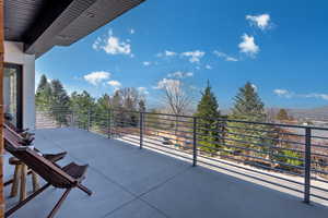 View of patio featuring a balcony