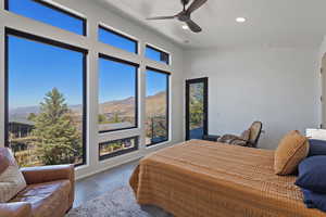 Bedroom with baseboards, recessed lighting, a ceiling fan, finished concrete floors, and a mountain view