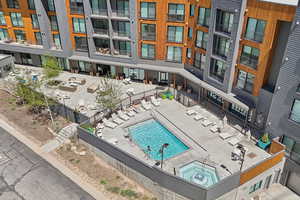 Community pool with fence and a hot tub