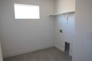 Clothes washing area featuring baseboards, laundry area, and hookup for a washing machine