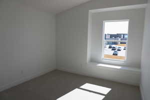 Unfurnished room featuring baseboards and carpet