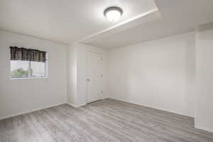 Unfurnished room with baseboards and light wood-style flooring