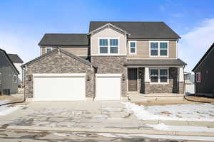 View of front of house with stone siding, a shingled roof, central AC unit, and concrete driveway