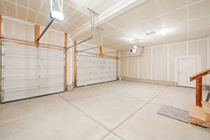Garage featuring a garage door opener