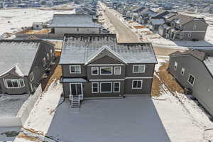 Snowy aerial view featuring a residential view