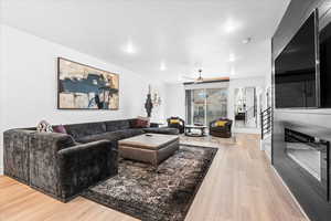 Living area featuring a ceiling fan, recessed lighting, and light wood-type flooring