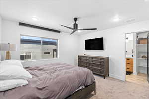 Carpeted bedroom featuring recessed lighting, baseboards, ceiling fan, visible vents, and ensuite bathroom