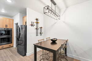 Dining area featuring baseboards and light wood-type flooring