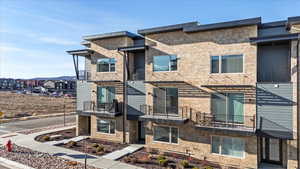 View of front facade featuring stone siding