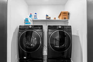 Laundry room with washing machine and clothes dryer and laundry area