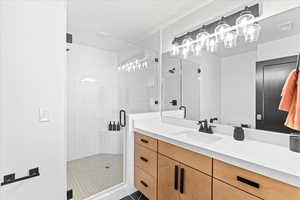 Bathroom with a shower stall and vanity