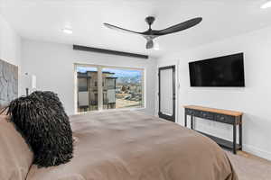 Bedroom featuring baseboards, access to outside, carpet flooring, and a ceiling fan