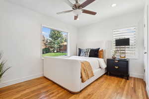 Bedroom featuring baseboards, light wood-type flooring, recessed lighting, and a ceiling fan