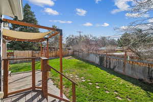 View of yard featuring a fenced backyard and a pergola