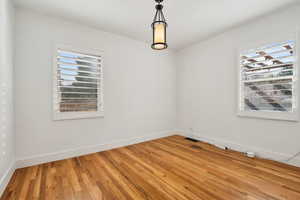 Unfurnished room with baseboards, visible vents, and light wood-type flooring