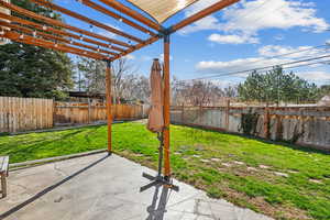 View of yard with a fenced backyard, a pergola, and a patio area