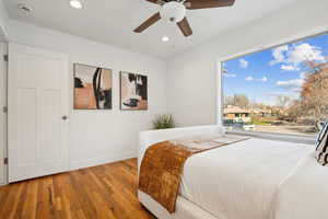 Bedroom featuring baseboards, wood finished floors, recessed lighting, and a ceiling fan