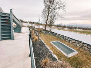 View of storm shelter featuring fence