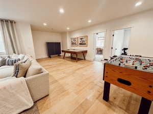 Rec room featuring baseboards, recessed lighting, and light wood-type flooring
