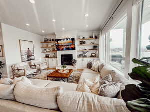 Living area with a fireplace and recessed lighting