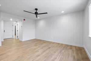 Spare room with baseboards, light wood-style flooring, ceiling fan, and recessed lighting