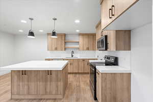 Kitchen with stainless steel appliances, light brown cabinets, a sink, open shelves, and light wood-type flooring
