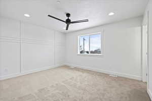 Unfurnished room with visible vents, baseboards, ceiling fan, recessed lighting, and light colored carpet