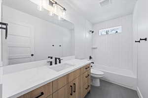 Full bath featuring visible vents, tub / shower combination, toilet, and vanity