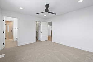 Unfurnished bedroom featuring recessed lighting, visible vents, a walk in closet, and carpet