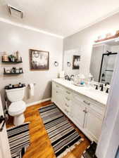 Full bath featuring visible vents, toilet, wood finished floors, a sink, and a stall shower