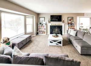 Carpeted living room featuring a fireplace