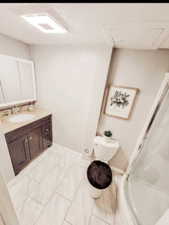 2nd Bathroom featuring walk in shower, baseboards, marble finish floor, toilet, and vanity