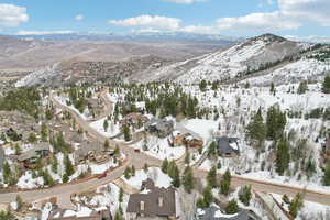 Snowy aerial view with a residential view and a mountain view