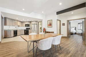 Dining room with light wood finished floors, recessed lighting, and baseboards