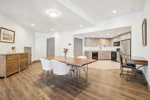 Dining room featuring recessed lighting, wine cooler, baseboards, and wood finished floors