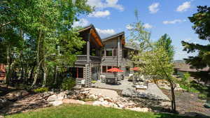 Rear view of house featuring a patio and a balcony