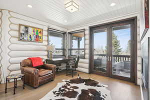 Office featuring log walls, wood finished floors, recessed lighting, french doors, and wood ceiling