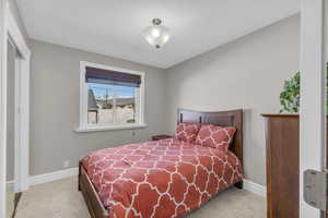 Carpeted bedroom with baseboards
