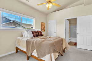 Bedroom with connected bathroom, baseboards, lofted ceiling, and carpet floors