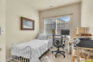 Carpeted bedroom featuring baseboards and visible vents