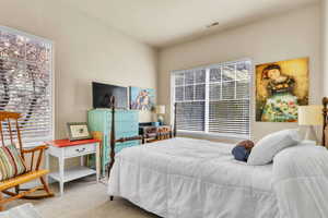 Carpeted bedroom with visible vents