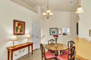 Dining area featuring a notable chandelier and visible vents