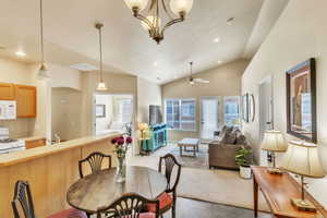 Dining space with lofted ceiling, recessed lighting, and a ceiling fan