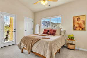 Bedroom with multiple windows, access to exterior, and carpet floors