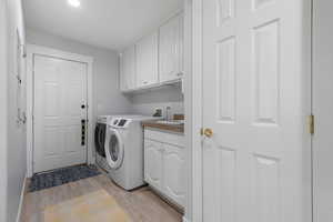Main floor laundry area with sink. Door leads to 3-car garage