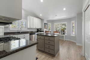 Well appointed, bright kitchen area with lots of cabinet space, a pantry, center island, granite counters, stainless steel appliances, gas range and breakfast nook