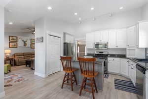 Kitchen open to the family room area with fireplace to the left